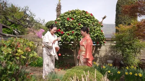 Two People in Kimono with Red Ball String Toy Stockbeeldmateriaal 344854971
