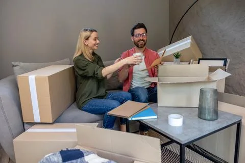Two people looking busy while packing the boxes for relocation Stock Photos