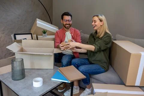 Two people looking busy while packing the boxes for relocation Stock Photos