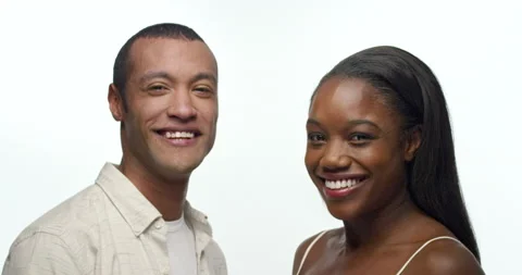 Two people looking at each other turn towards camera and smile. Stock Footage 138607726