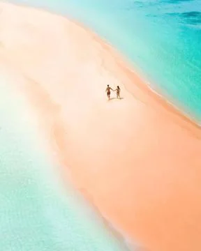 Two people in the middle of a beach Fotos de archivo