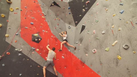 Two people moving up the climbing wall. Stock Footage 104450674