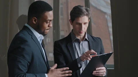 Two people multi-ethnic colleagues men afro american man investor boss and Stock Footage 151704748