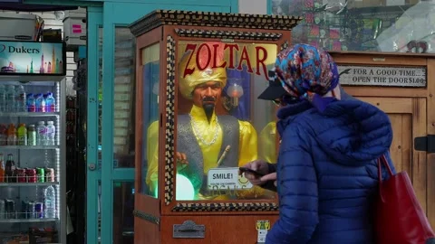 Two people next to Zoltar fortune teller machine. slowed to half speed Stock Footage 164779161