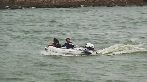 Two people playing in dinckey in the waves. Video stock 95551351