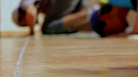 Two people in prayer prostrate on the smooth floor of a mosque under soft Stock Footage 313479941