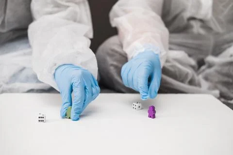 Two people in protective white translucent suit, blue rubber gloves, medical Stock Photos