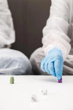 Two people in protective white translucent suit, blue rubber gloves, medical Stock Photos