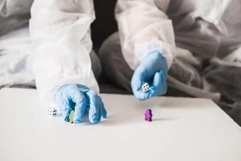 Two people in protective white translucent suit, blue rubber gloves, medical Stock Photos