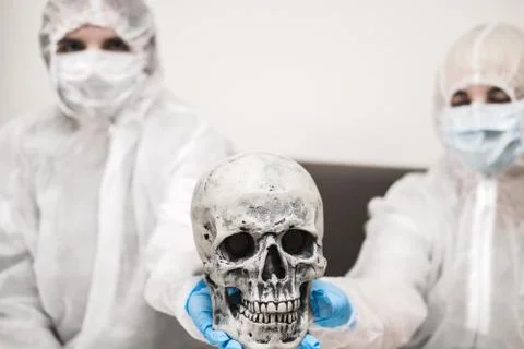 Two people in protective white translucent suit, blue rubber gloves, medical Stock Photos