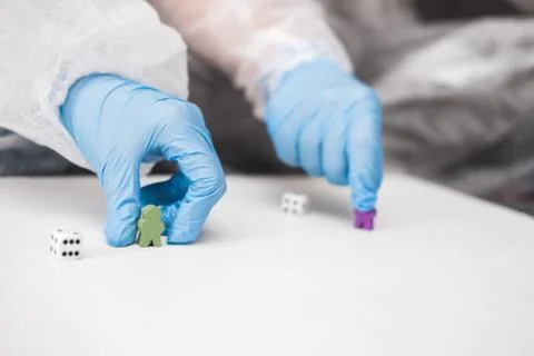 Two people in protective white translucent suit, blue rubber gloves, medical Stock Photos