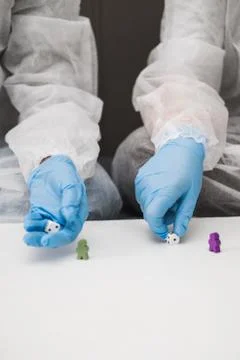 Two people in protective white translucent suit, blue rubber gloves, medical Stock-Fotos
