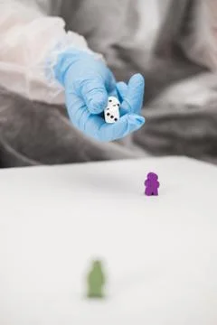Two people in protective white translucent suit, blue rubber gloves, medical Stock Photos
