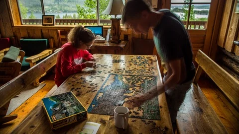 Two People Puzzling in Cabin Stock Footage 88231914
