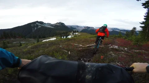 Two people riding bikes with mountain views Video stock 87054786