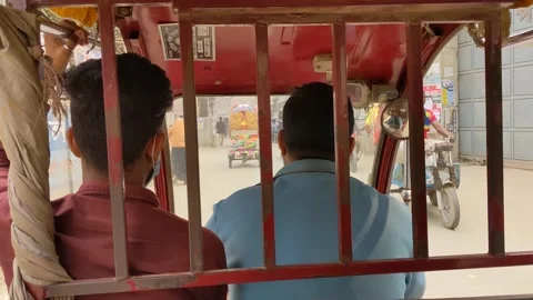 Two people riding in an Indian auto rikshaw Stock Footage 146579941