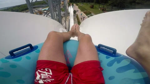 Two people rolls down the hill on a air circle in the aquapark 스톡 동영상 102088712