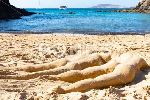 Two people from sand sculpture on sandy Papagayo beach on the island of Lanza Stock Photos