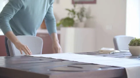 Two people setting the table up in living room putting dishes for meal while 動画素材 129259507