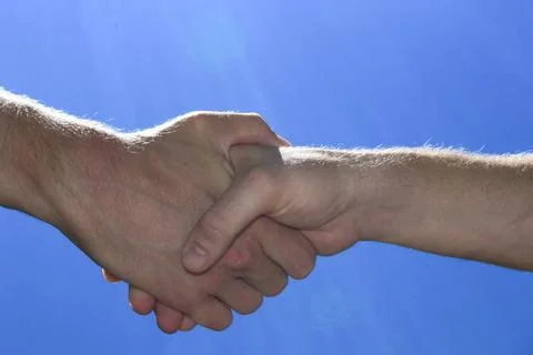 Two people shake hands Stock Photos
