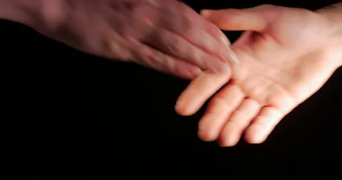 Two people shaking hands over black Stock Footage 105952323