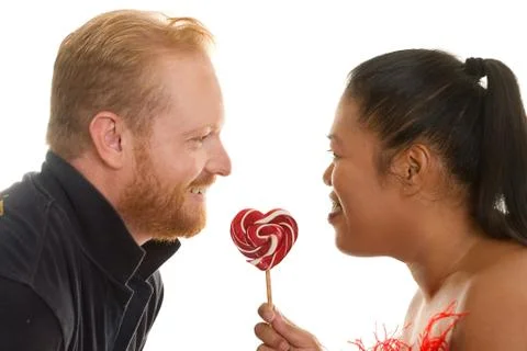 Two people share a candy Stock Photos