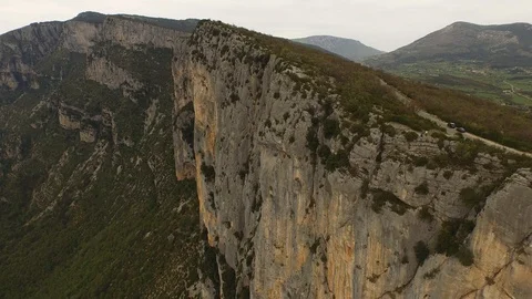 Two people sitting and talking on the top of cliff over a rocky gorge and a Video stock 101598386