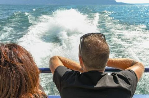 Two people sitting on the back of a fast ferry Stock Photos