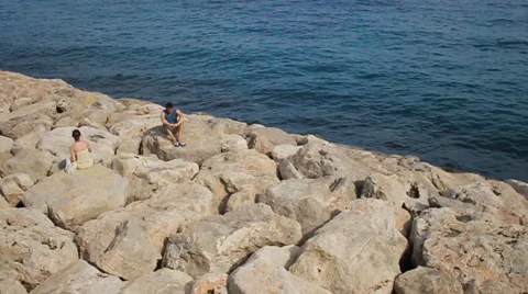 Two people sitting separated on the rocks Stock-Footage 46011286