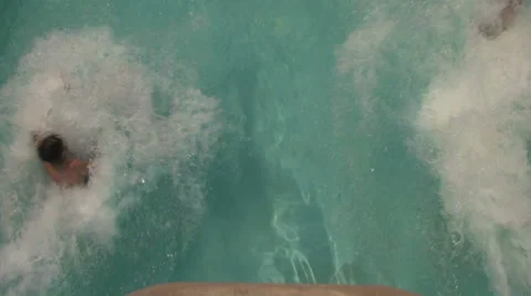 Two People Splashing Into Pool From Water Slide Stock Footage 25902413