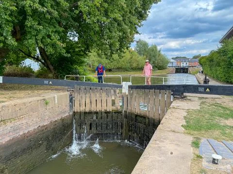 Two people standing on a lock gate in Worcester, Stock Photos