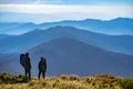The two people standing on the mountain Photo