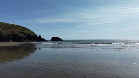 Two People Standing on Sandy Beach with Gentle Sea Waves 4K Stockbeeldmateriaal 333933441