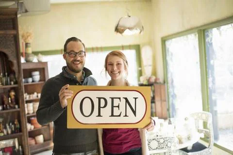Two people standing in a store full of antique objects, a couple running a bu Stock Photos