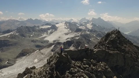 Two people standing on the top of a mountain, Verbier, Switzerland Video stock 101579998