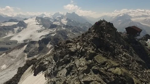 Two people standing on the top of a mountain, Verbier, Switzerland Video stock 101580129