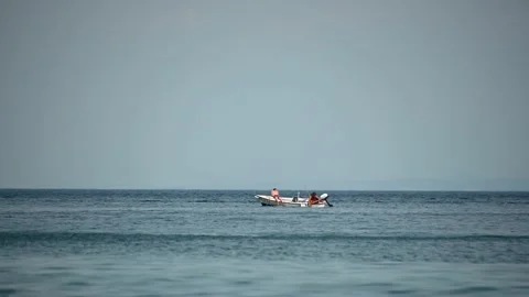 Two people sunbathing on a small boat in Adriatic Sea Stock Footage 159017619