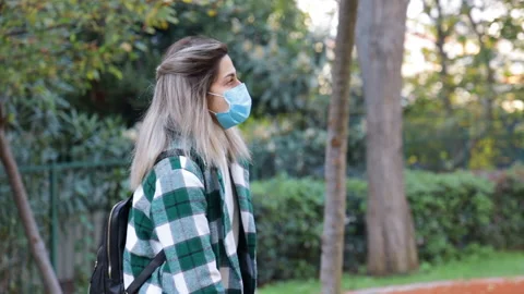 Two people talking in the park having discussion, wearing COVID-19 medical mask Stock Footage 144442465