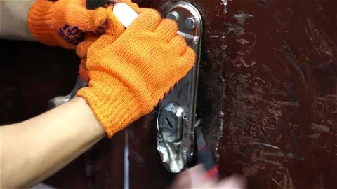 Two people try to break the lock in the door Stock Footage 115048245
