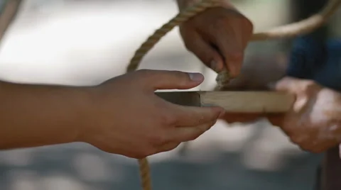 Two people try to put rope to the hole Stock Footage 52316524
