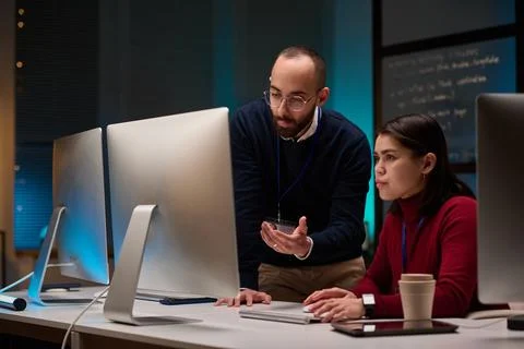 Two People using Computers and Coding with Blue Lights 库存照片