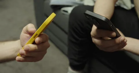 Two people using smartphones close-up hands interaction Stockbeeldmateriaal 333030221
