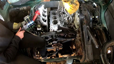 Two people using a tool to insert piston into cylinder head Stock Footage 171470836