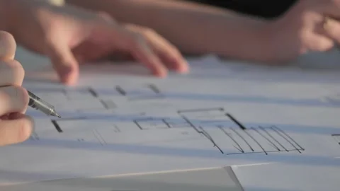 Two people viewing plans in evening light Video stock 288992336