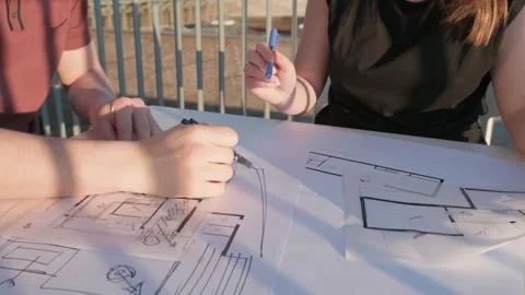 Two people viewing plans in evening light Stock Footage 288992385