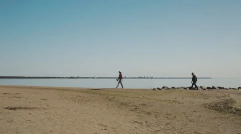 Two people walk on the beach. Stock Footage 54641260