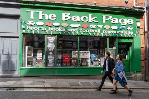 Two people walk past The Back Page football memorabilia shop, Newacstle upon Tyn Stock Photos