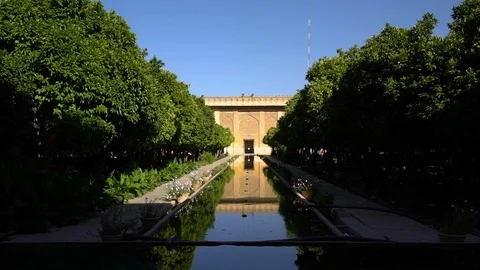 Two people walking along a pool and garden Stock-Footage 100845482