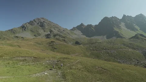 Two people walking in the Alps Mountains, Verbier, Switzerland Stock Footage 101577134