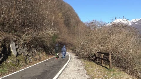 Two people walking on the cycle route of Valsassina with cold weather Video stock 150864061